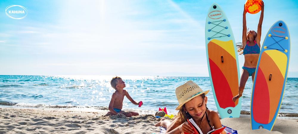 Three kids playing around two paddle boards