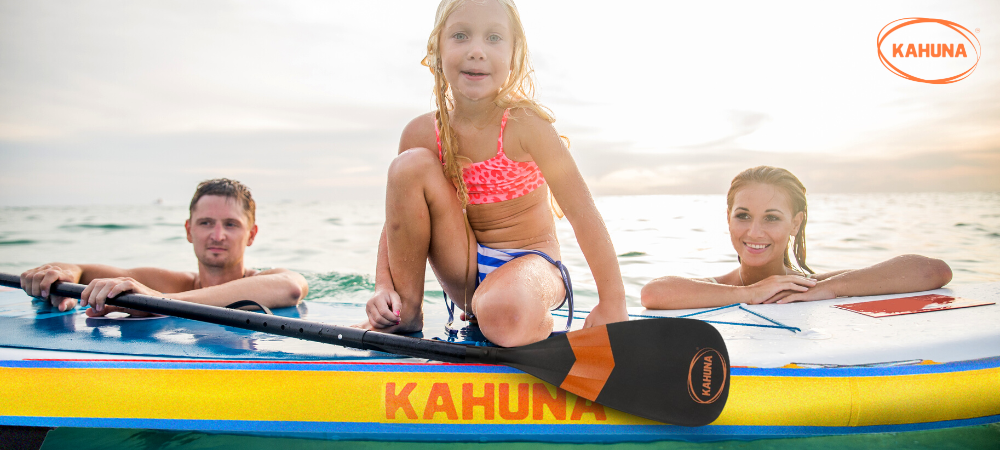 Young girl kneeling on a Kahuna Stand-up paddle board