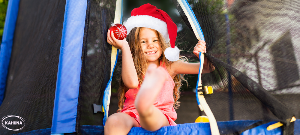 Young girl with a Santa hat on a trampoline
