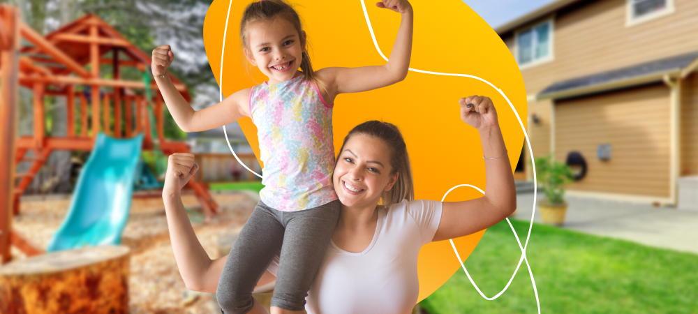 A mom and daughter smiling while flexing their arms 