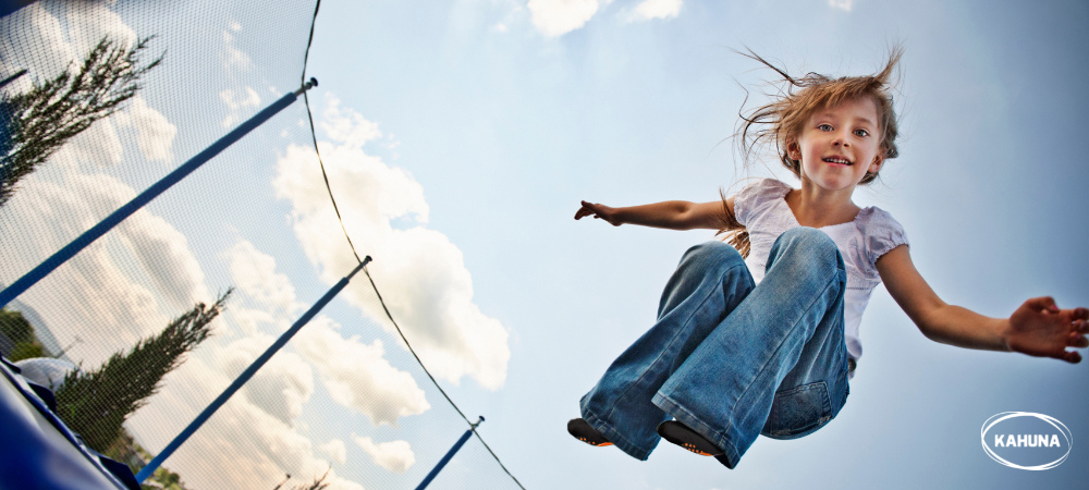 A young girl wearing trampoline socks while jumping