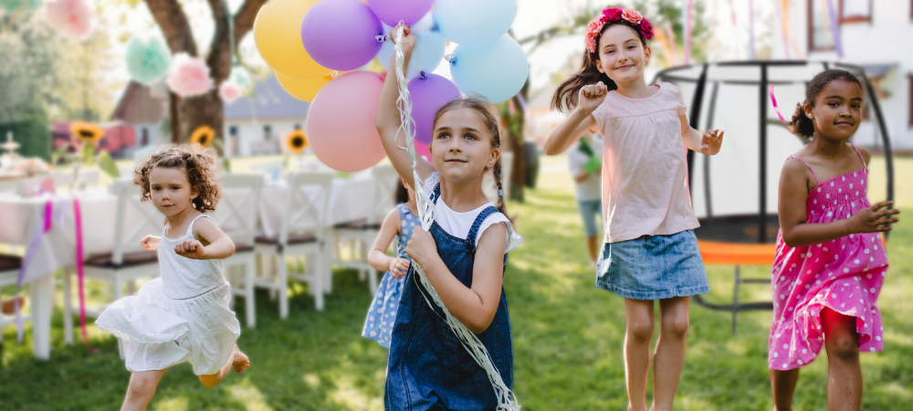 Girls running around a trampoline during a birthday party