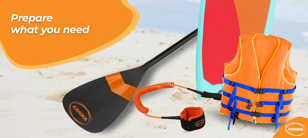 Kahuna paddle, leash and paddleboard next to a PFD