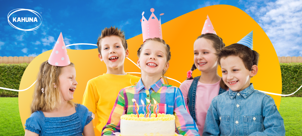 Five kids with party hats around a birthday cake 