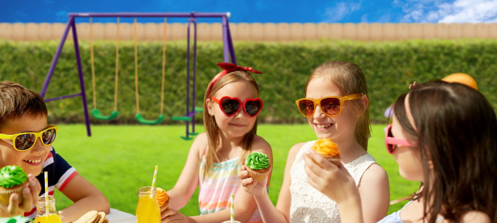 Kids in shades enjoying cupcakes near a swing set
