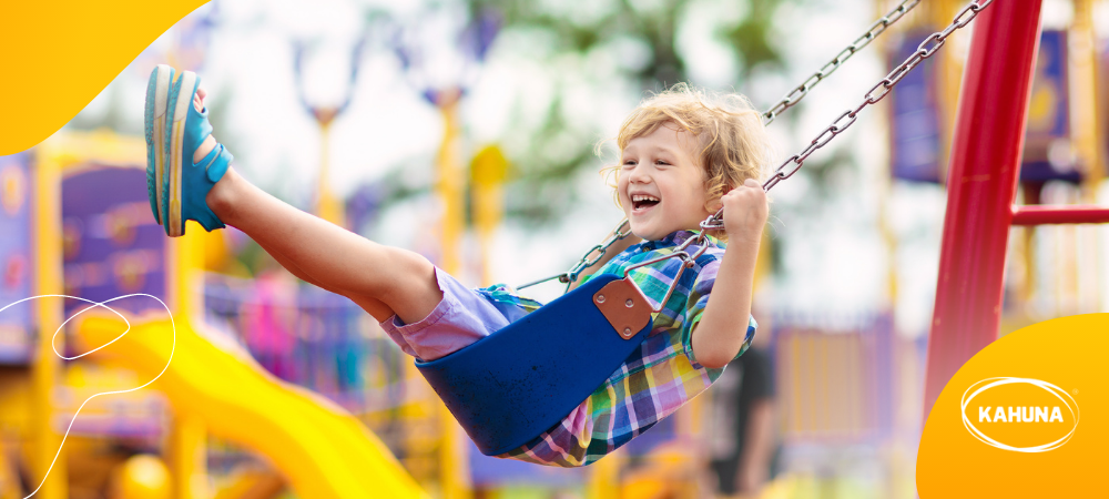 Happy child swinging outdoors 
