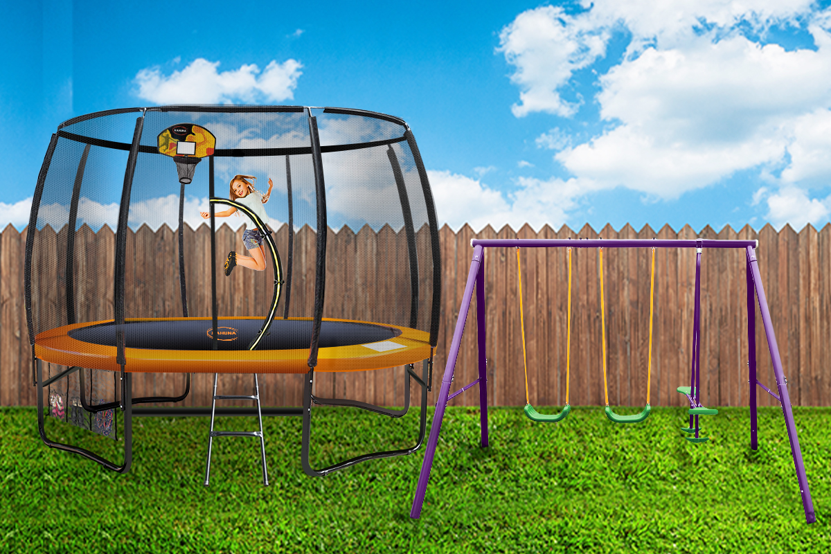 A yard with a trampoline and swing set