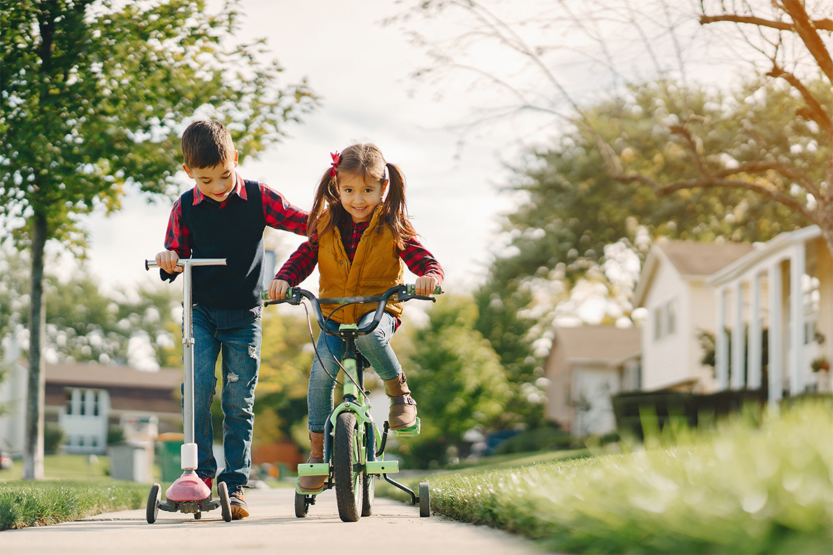 Two young children biking during autumn school break